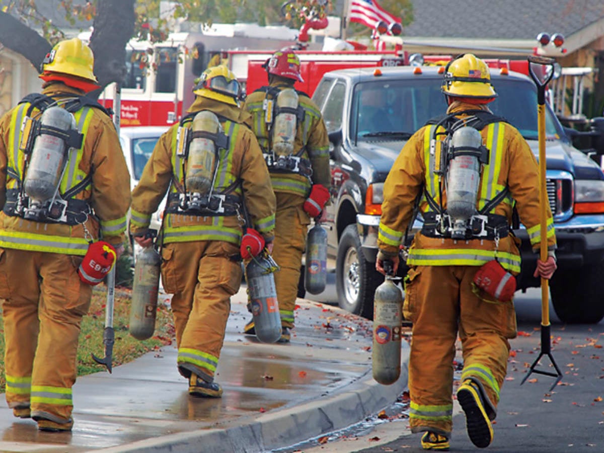 firefighters next to their truck