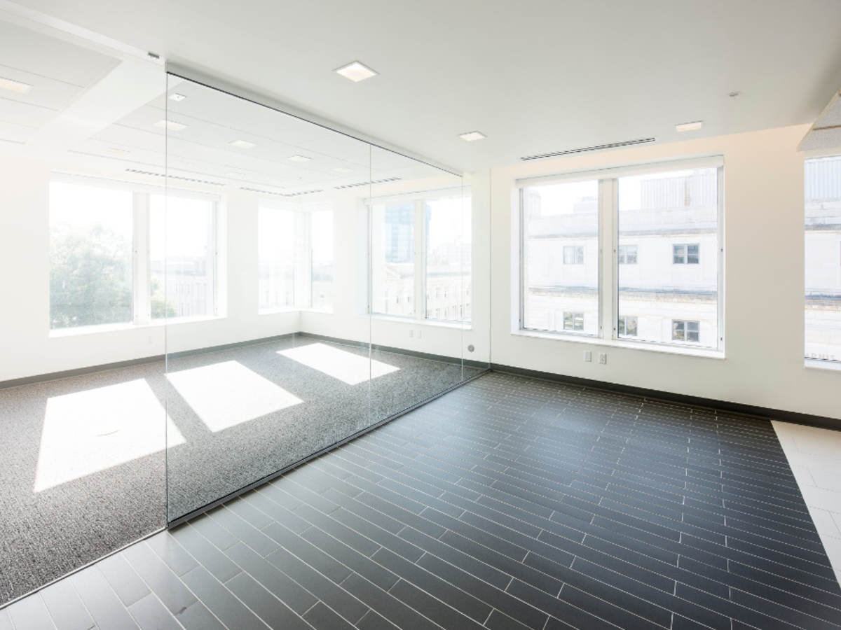 Airy unfurnished office with several kinds of tile flooring
