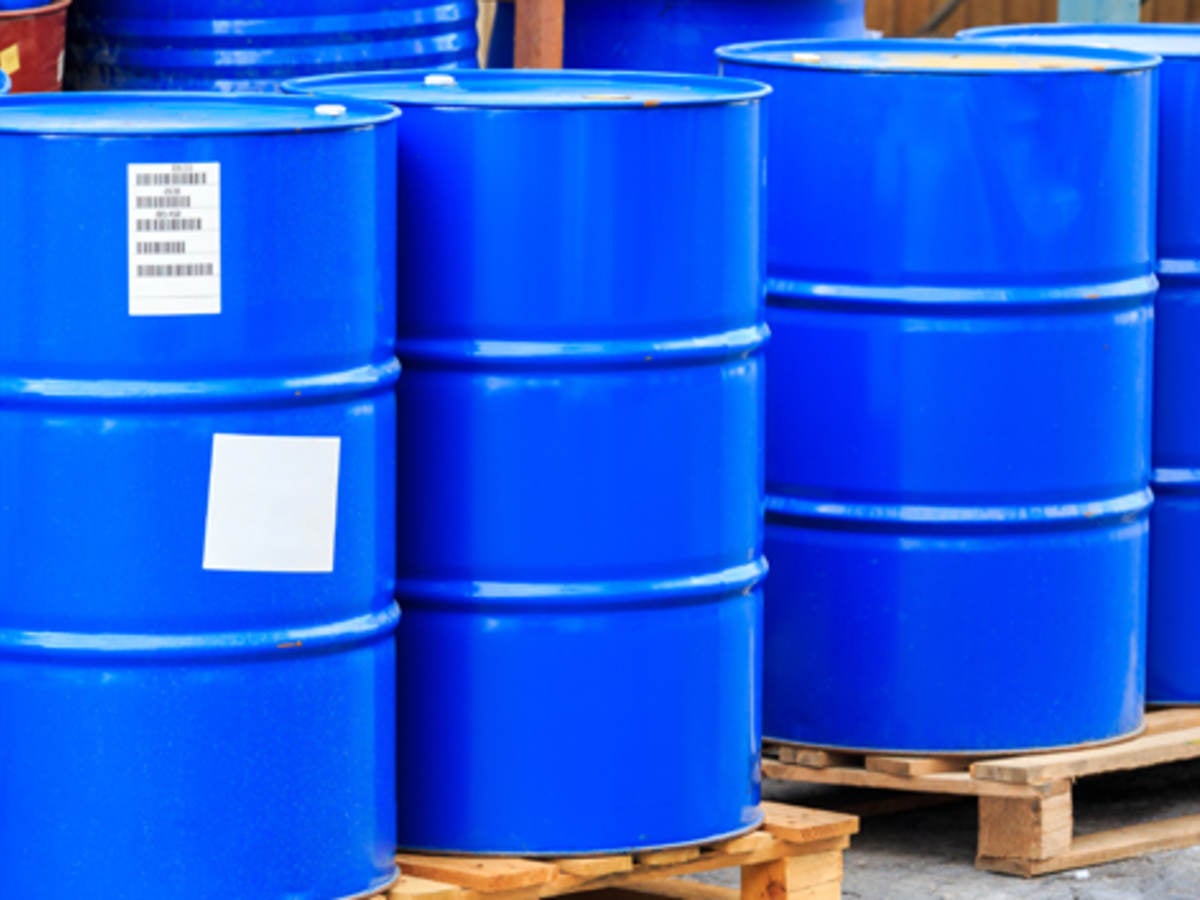 Large blue barrels on plywood boards