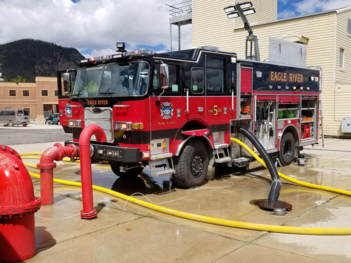 A parked fire truck receiving maintenance.