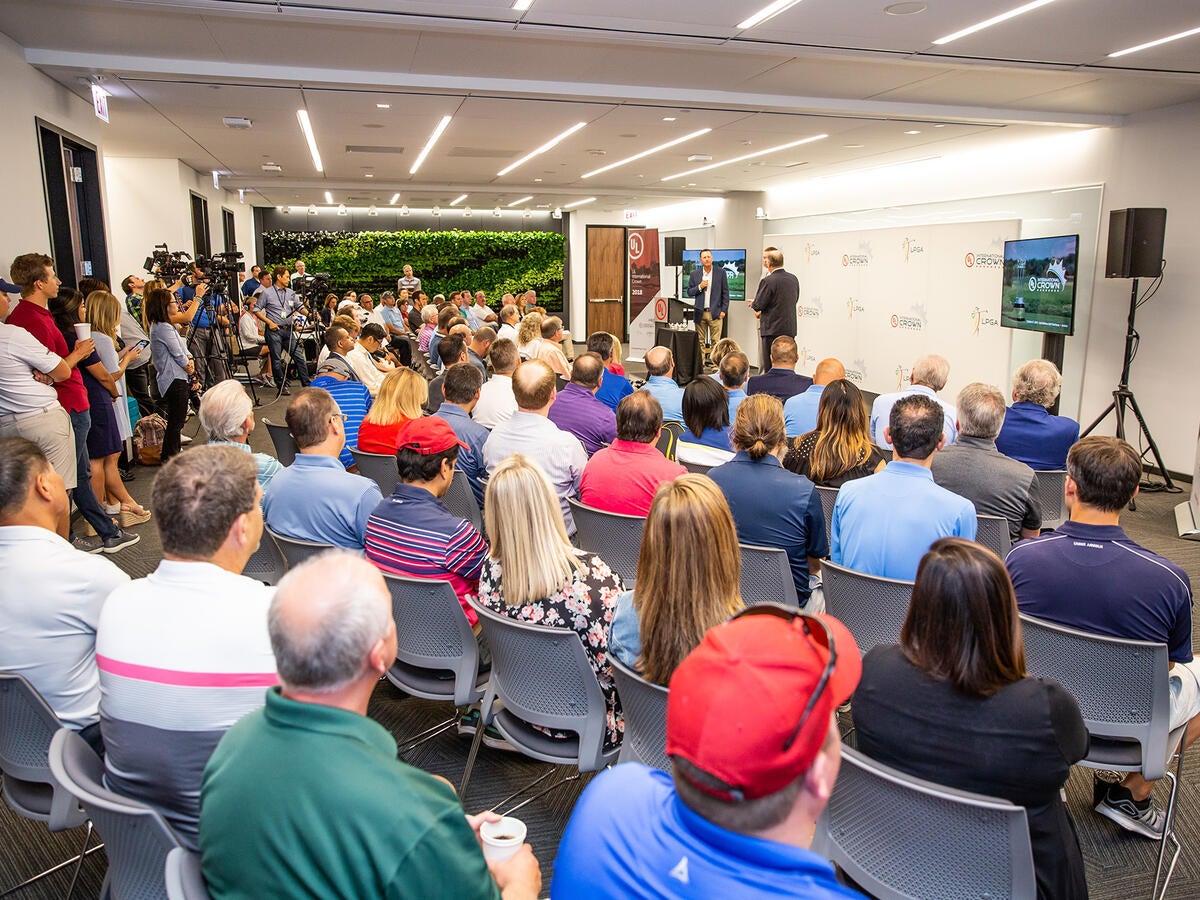 Photo of a crowd attending a presentation in a large view.