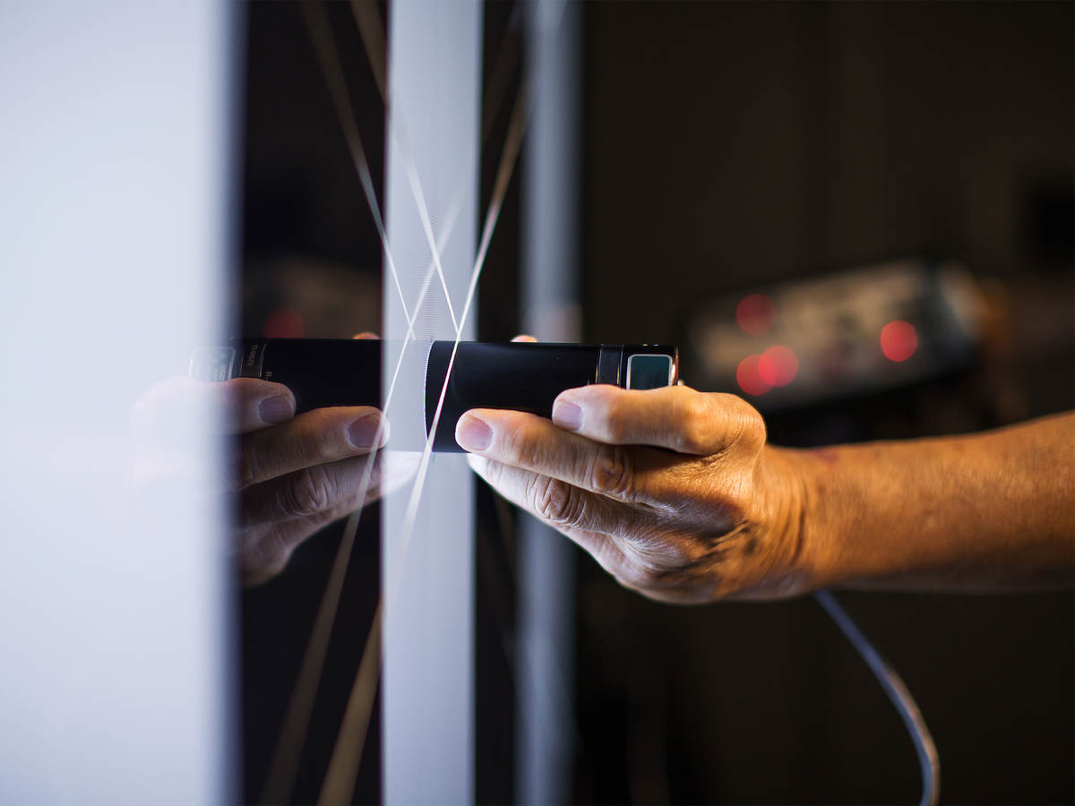 scientist takes measurement on glass