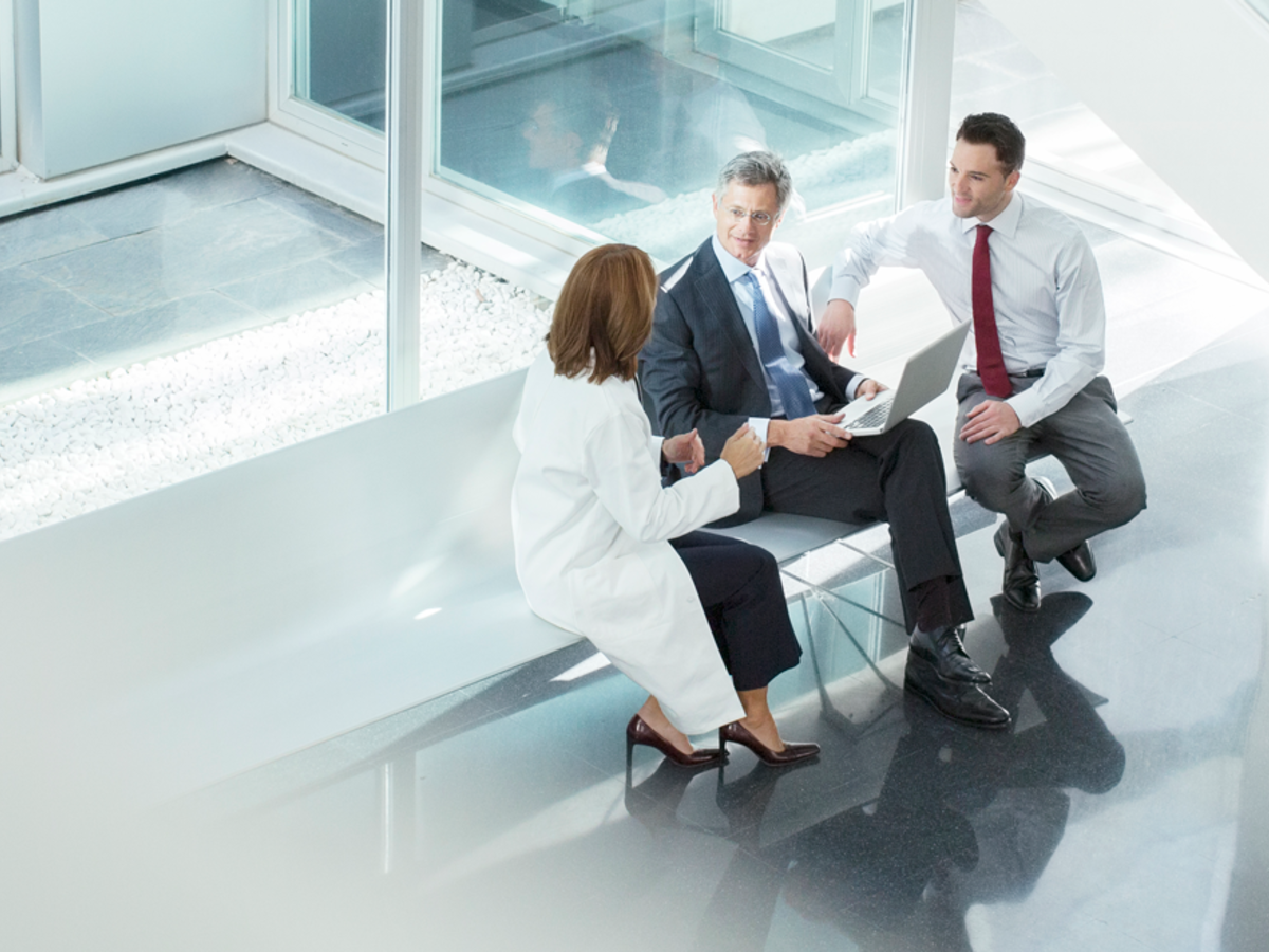 3 persons sitting on bench new glass window talking