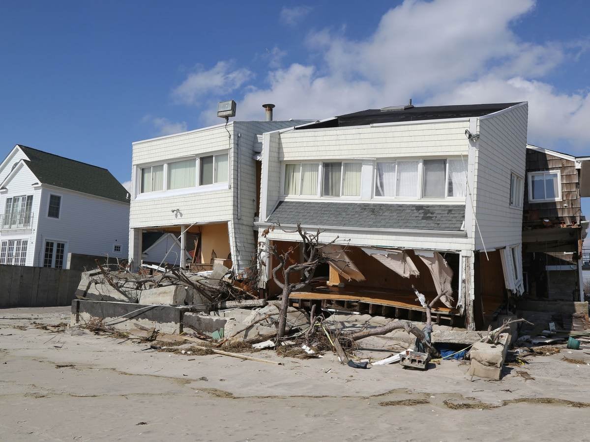A white clad destroyed beach house four months after Hurricane Sandy.