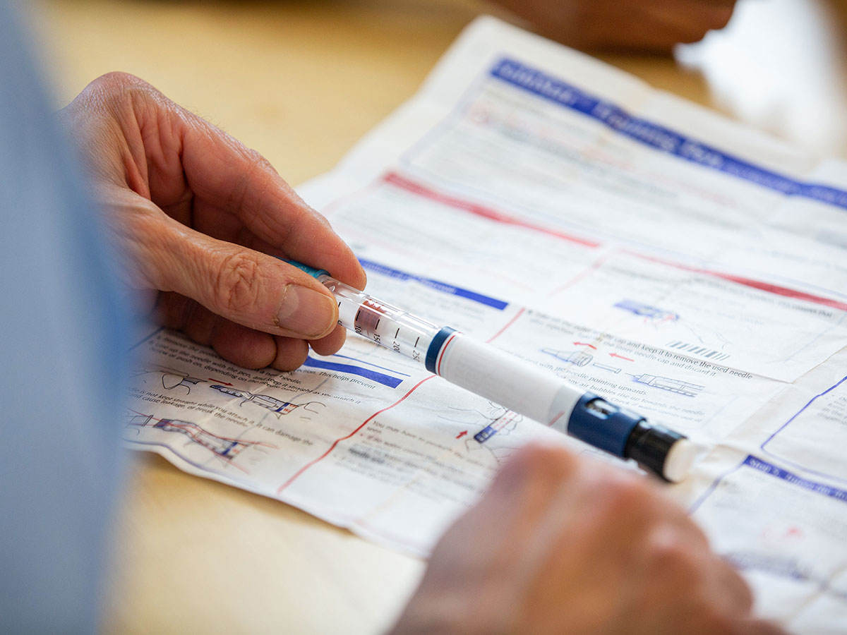 Person holding a needle