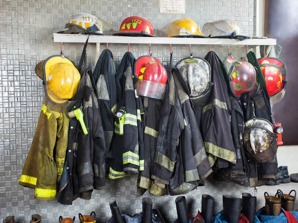 Firefighter gear hangs in a row, waiting for the next call