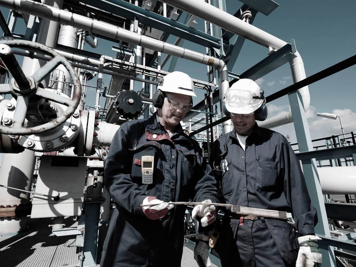 Oil and gas workers confer inside large refinery industry
