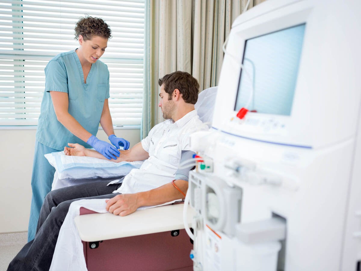 healthcare provider administering a medical test in front of medical equipment