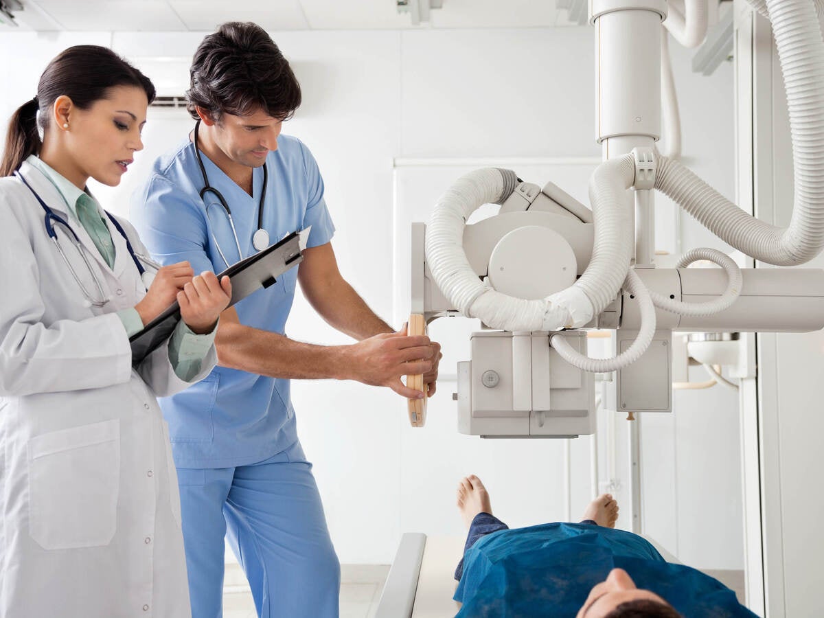 medical technician operating equipment