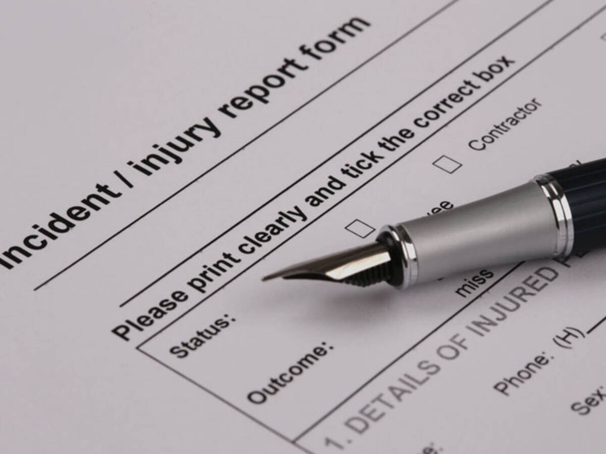 Up close image of an injury report form with pen 
