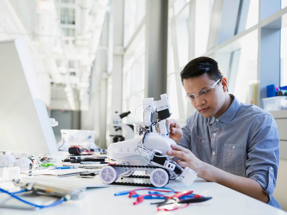 Worker working on a small robot