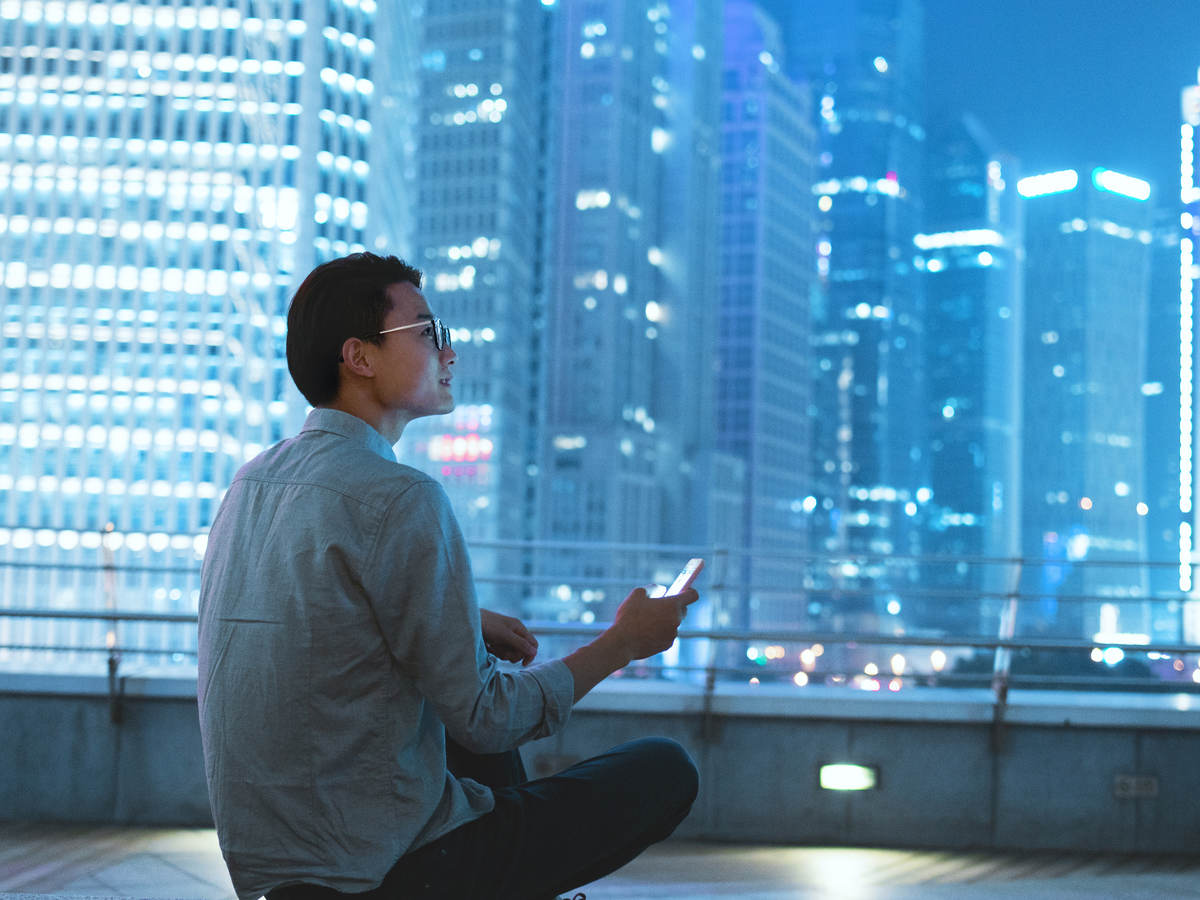Guy on a roof with a smartphone