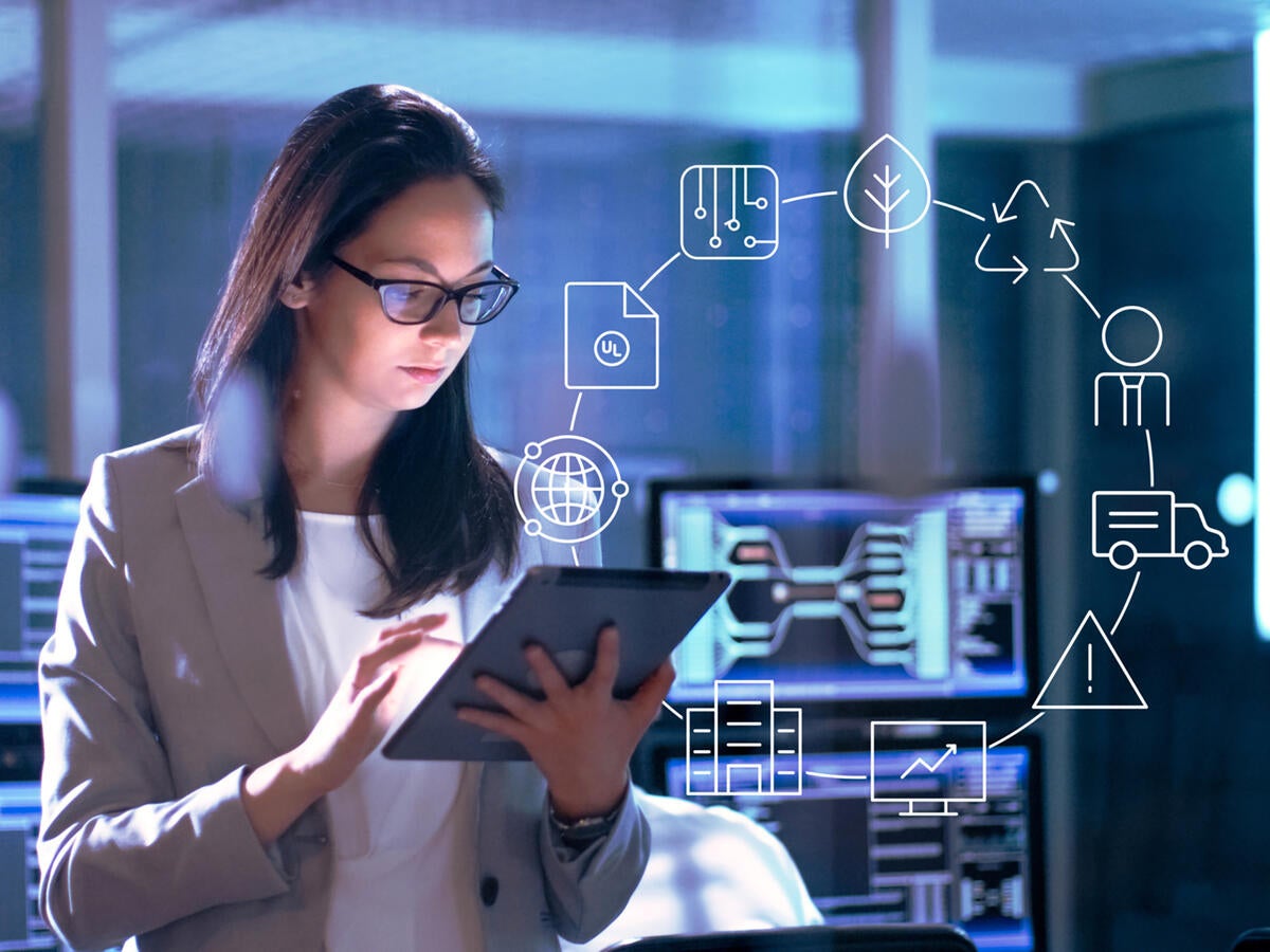 Photo of a woman in a lab working on a tablet