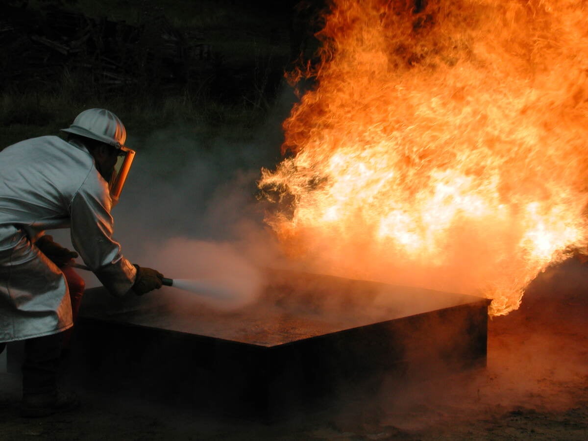 Firefighter fighting a practice fire