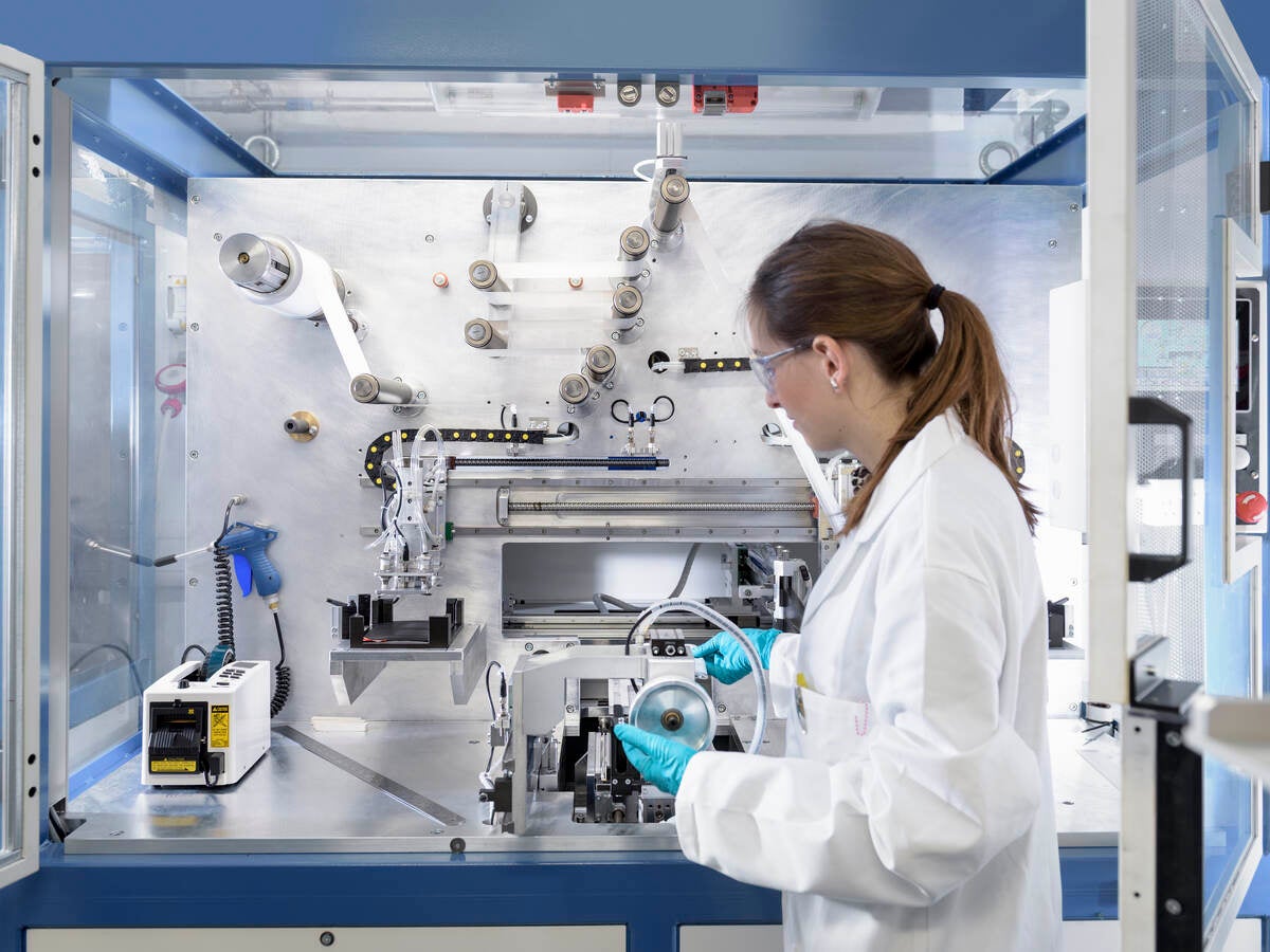 Scientist making lithium ion battery samples in battery research facility