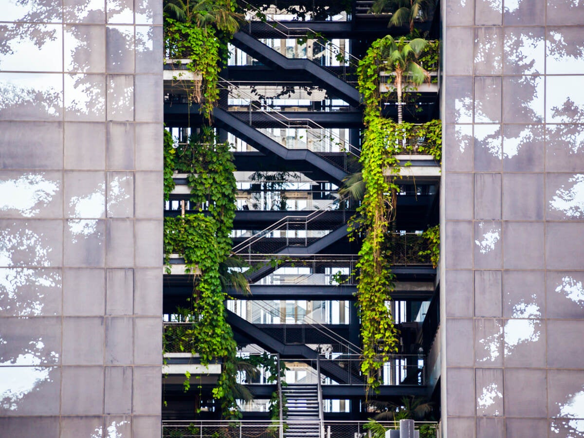 Beautiful architecture building with levels and vegetation growing inside of the building.