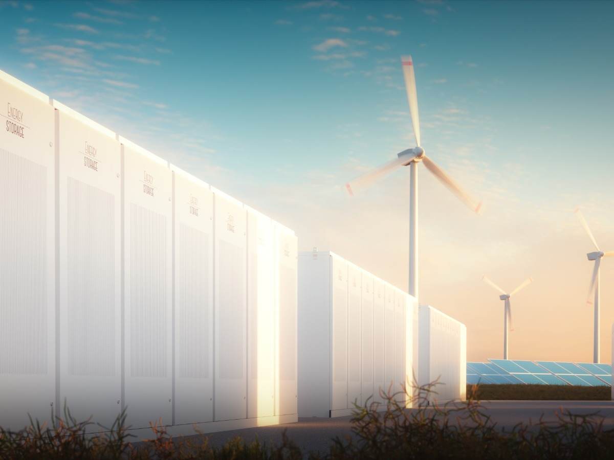 Large scale energy storage with solar panels and wind turbines in background