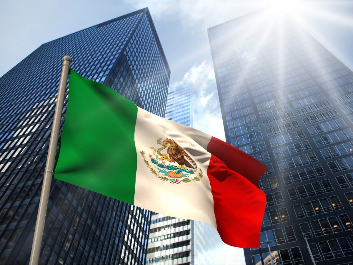 Mexico Flag with sky scrapers in background 