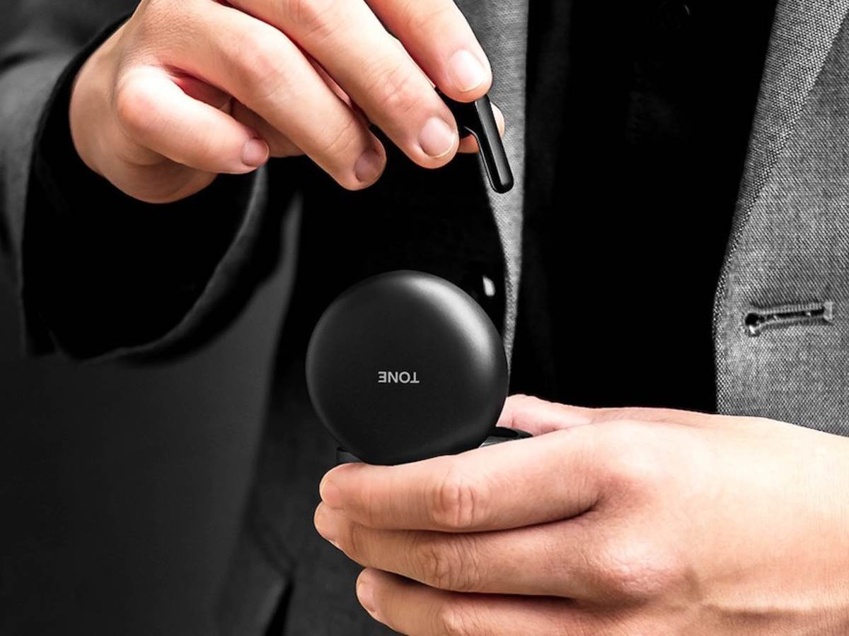 Man holds LG TONE Free™ wireless earbuds case in his hands