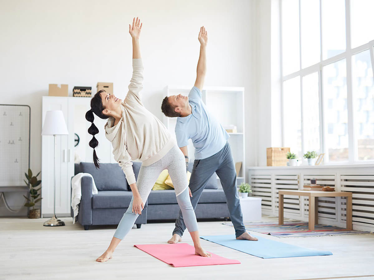 Photo of a couple doing yoga in activewear