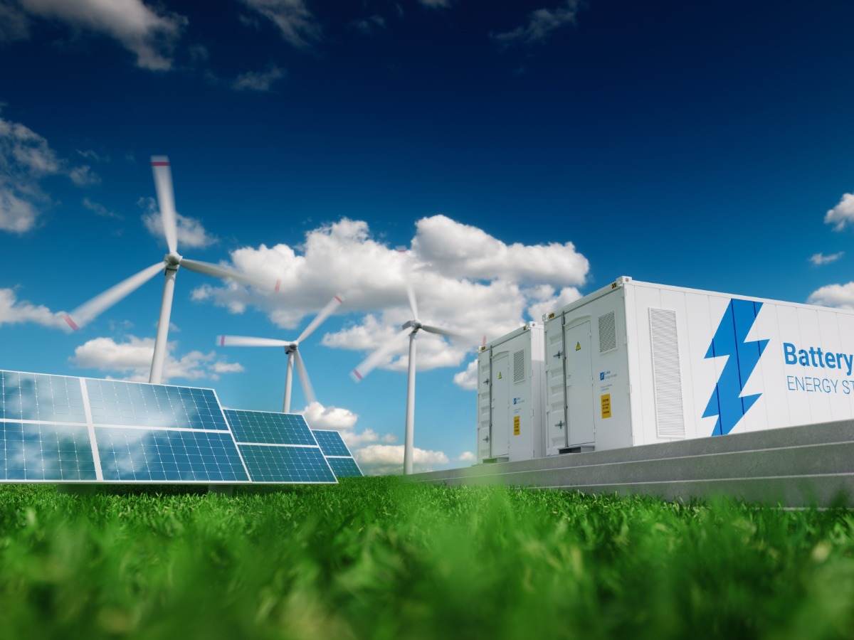 Photovoltaics, wind turbines and Li-ion battery container in fresh nature.