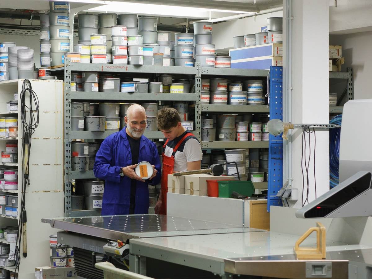 Workers looking at a paint can