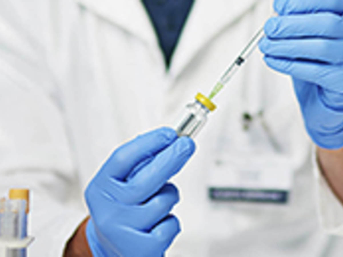 scientist with vial and syringe 