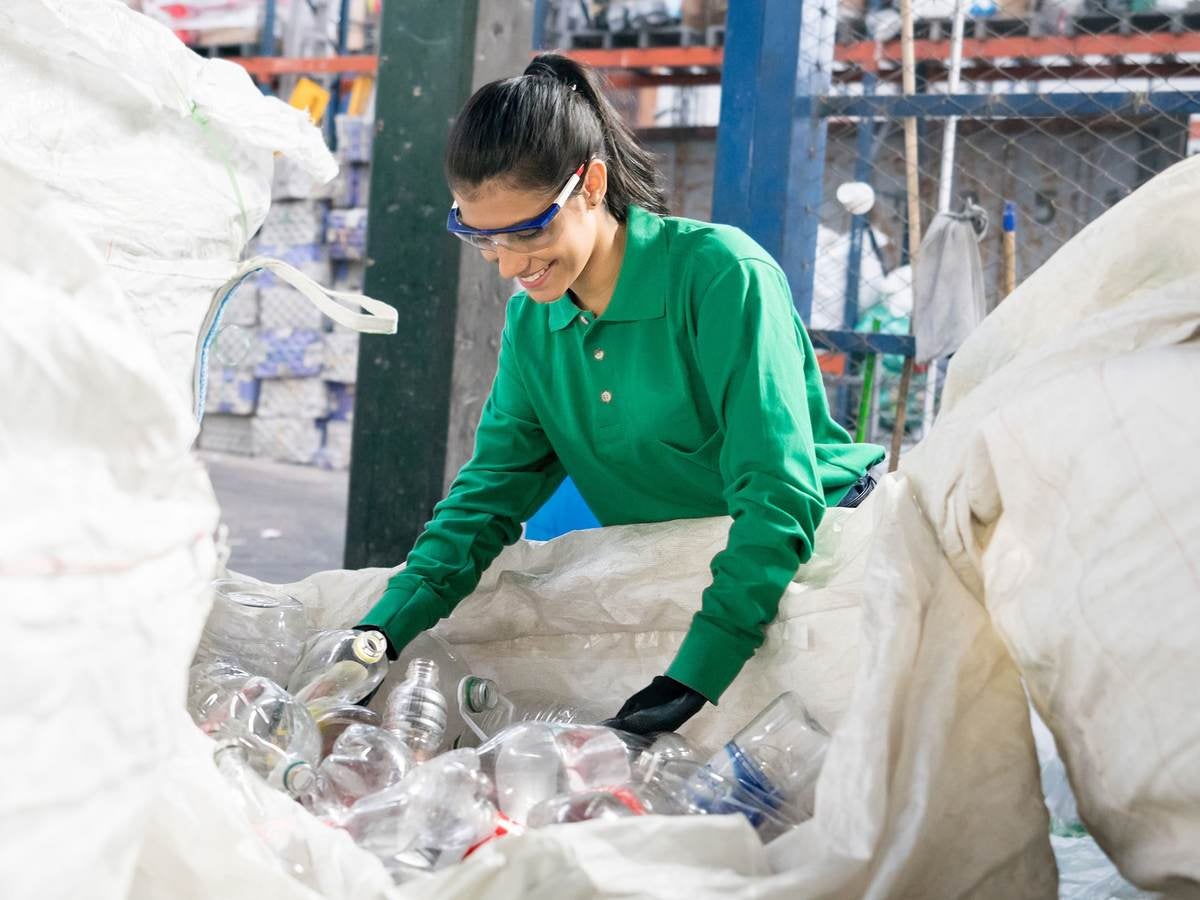 woman looking at plastic recycled bottles