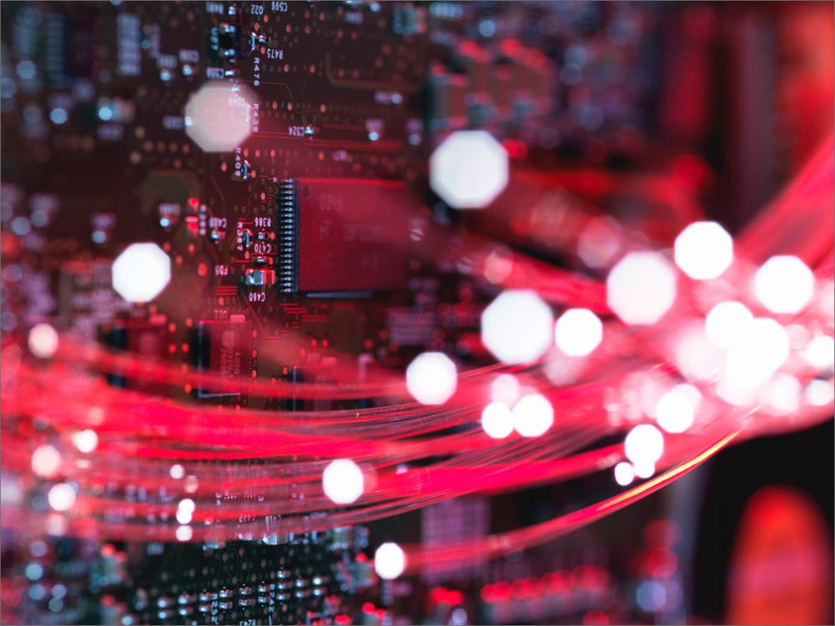 Close-up of fiber optics flowing through circuit boards 
