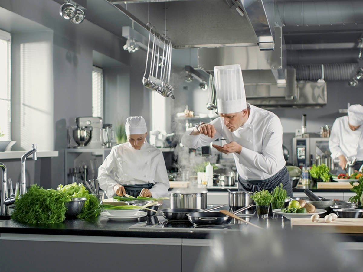 foodservice professionals (chefs) in a high-end commercial kitchen 