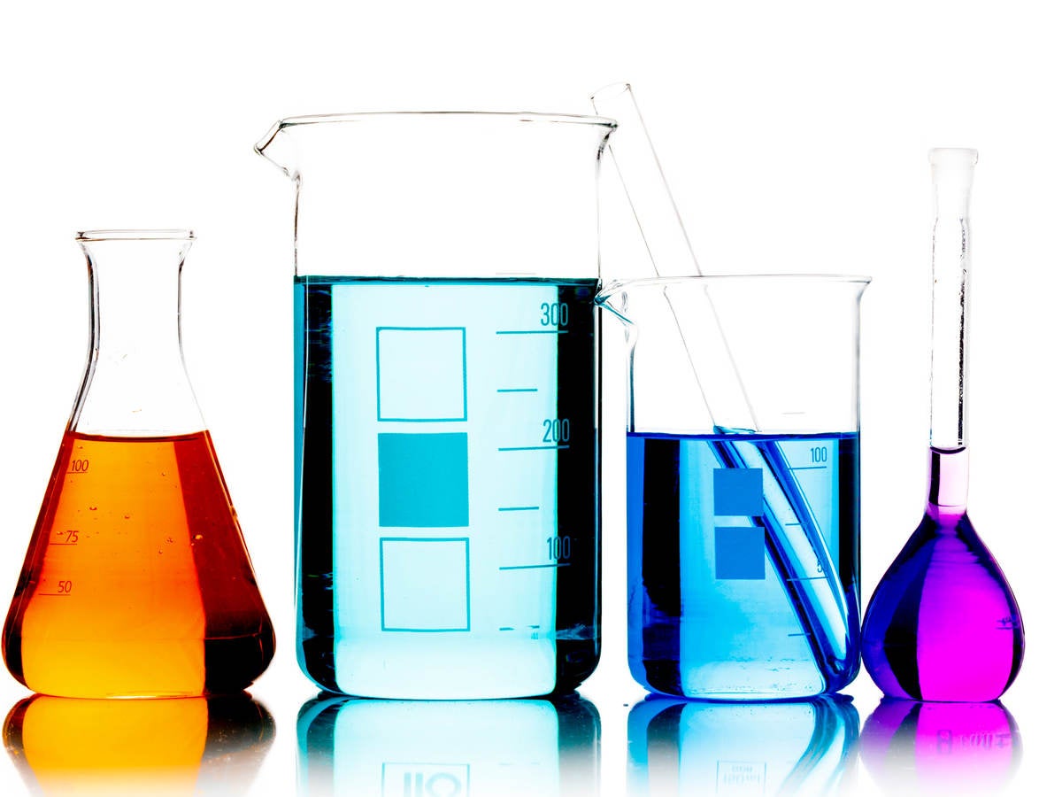 Lab beakers containing different colored liquids