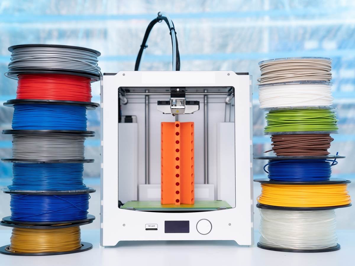 Spools of 3D printing filament and a 3D printer