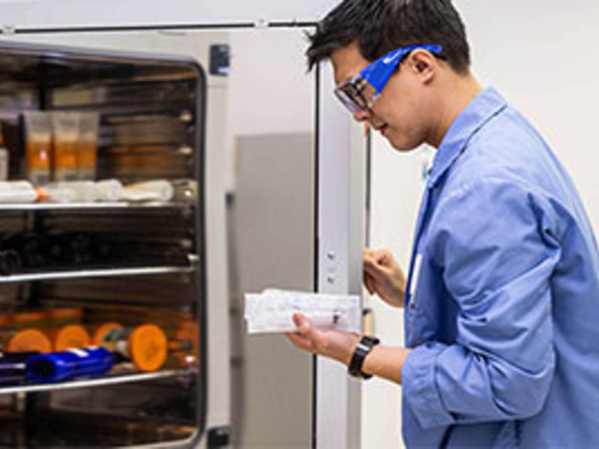 lab tech with refrigerator 
