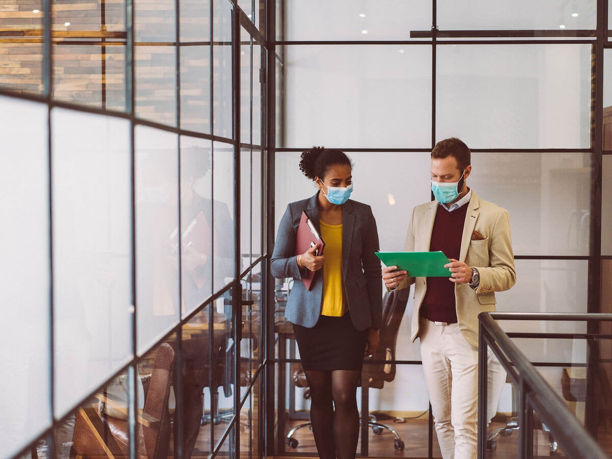 Colleagues wearing masks in the workplace