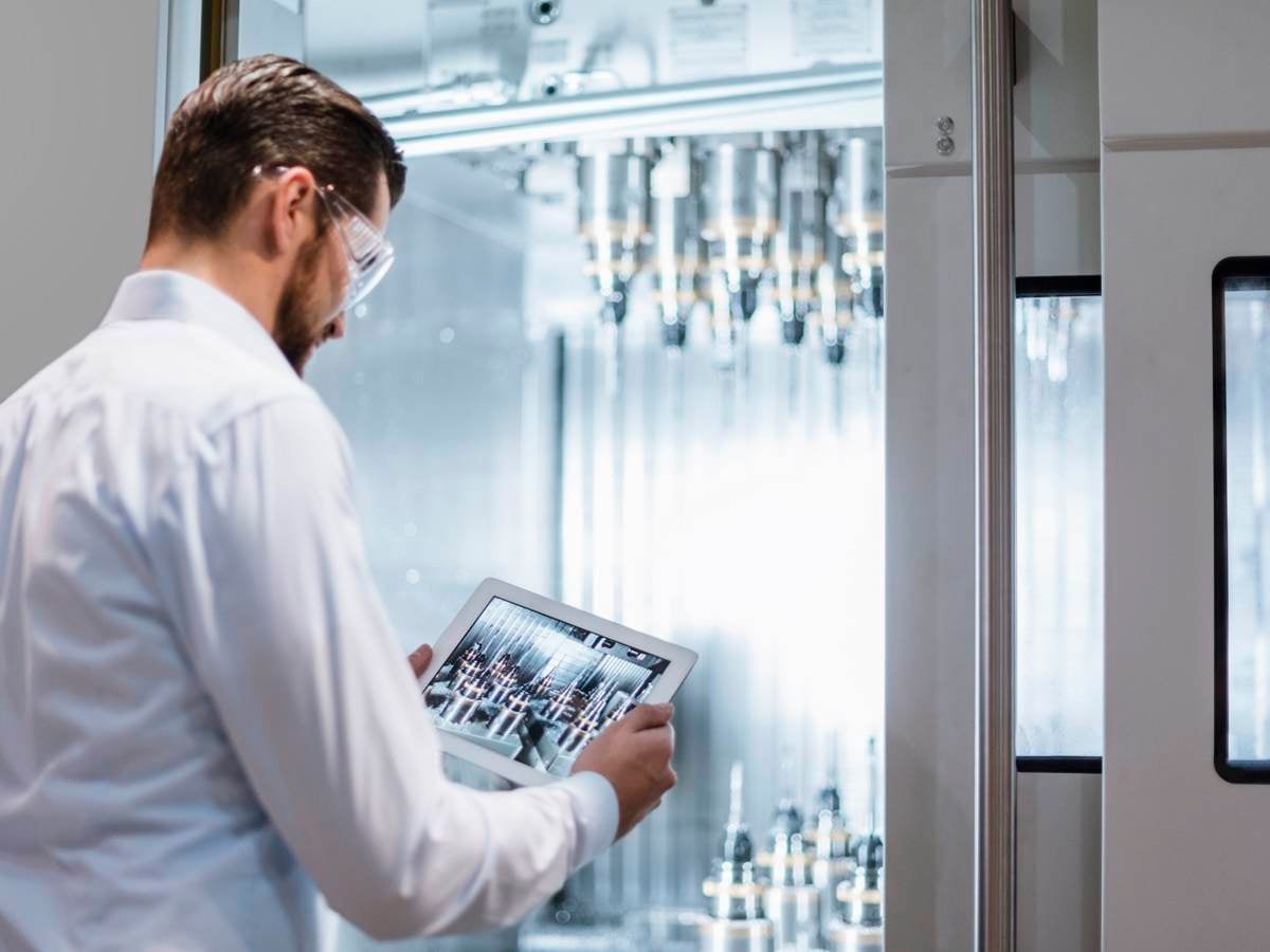 Scientist looking at a tablet while conducting some analysis