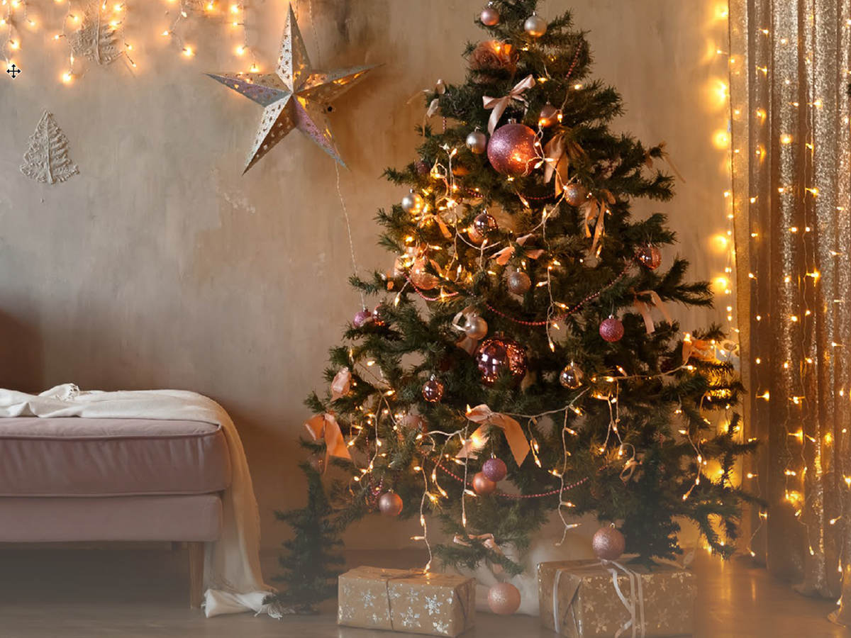 A living room with pre-lit Christmas tree and other lit decorations