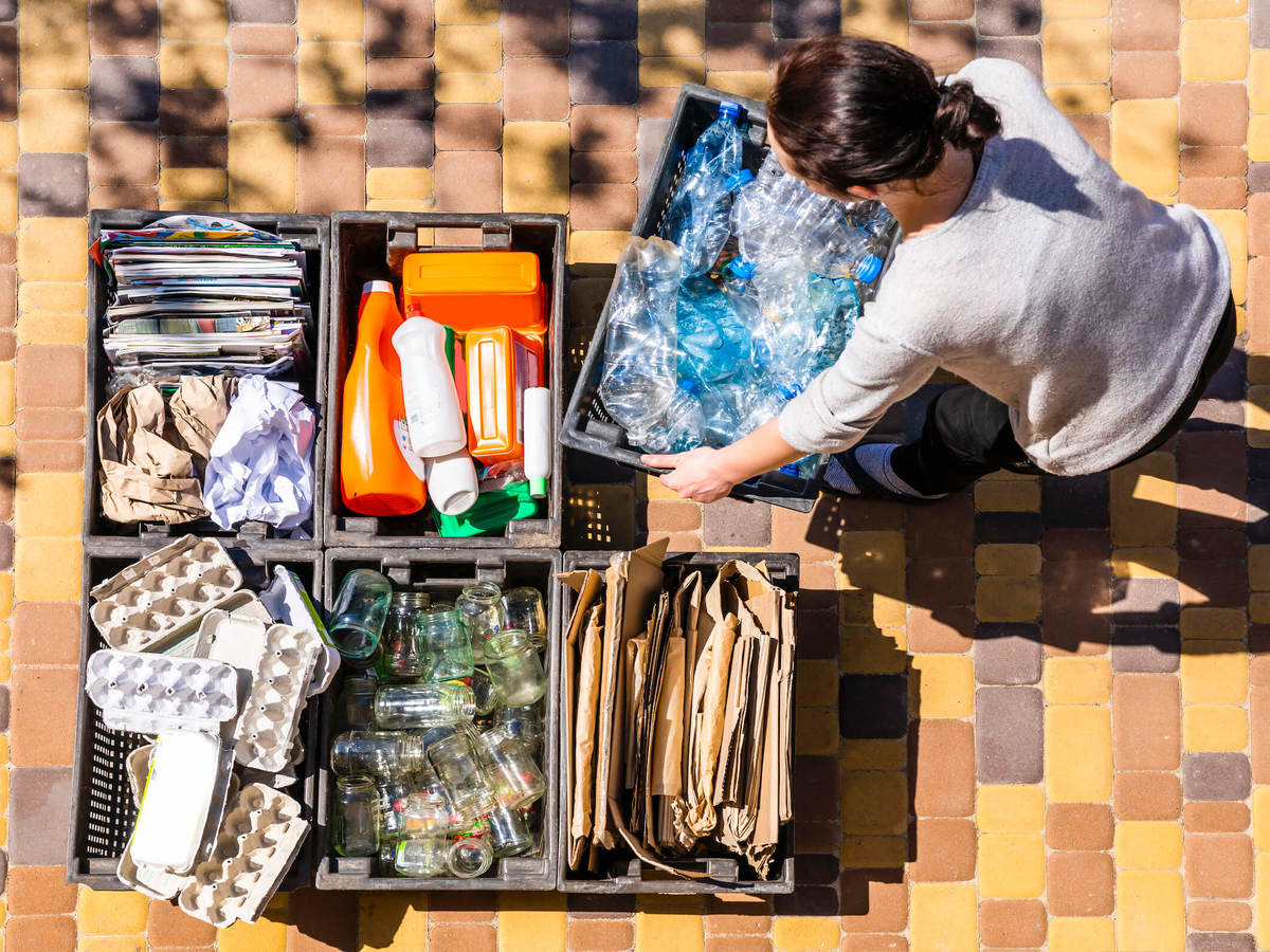 Woman sorts materials for recycling