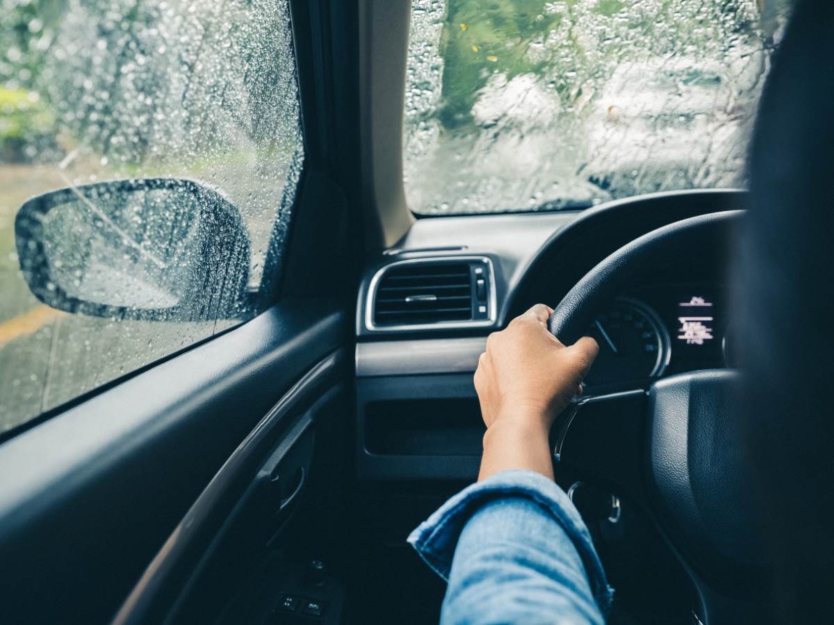 Man driving car in rain