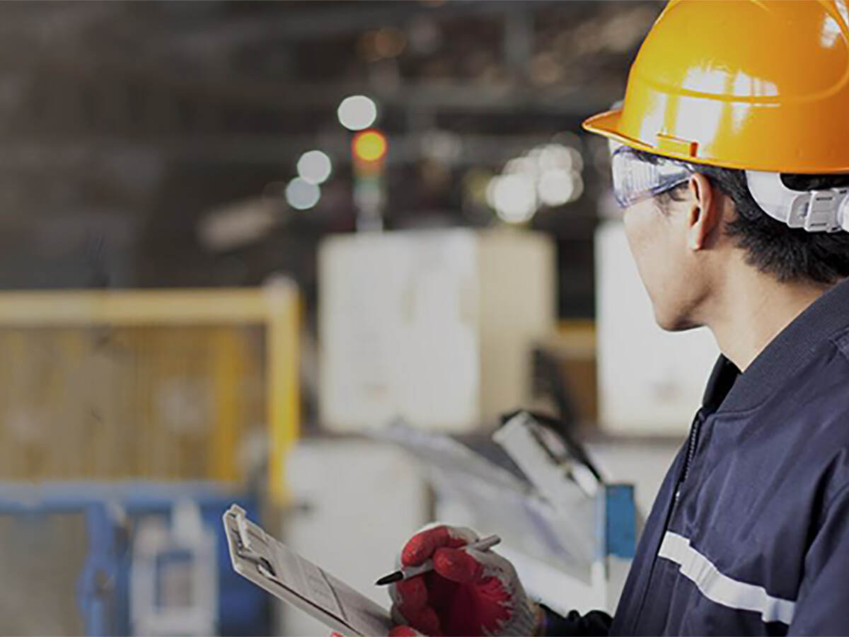 Man with clipboard in a facility