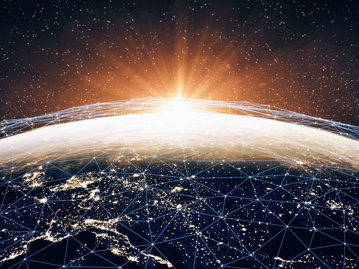 A series of interconnecting points of light across the earth, representing cybersecurity. 
