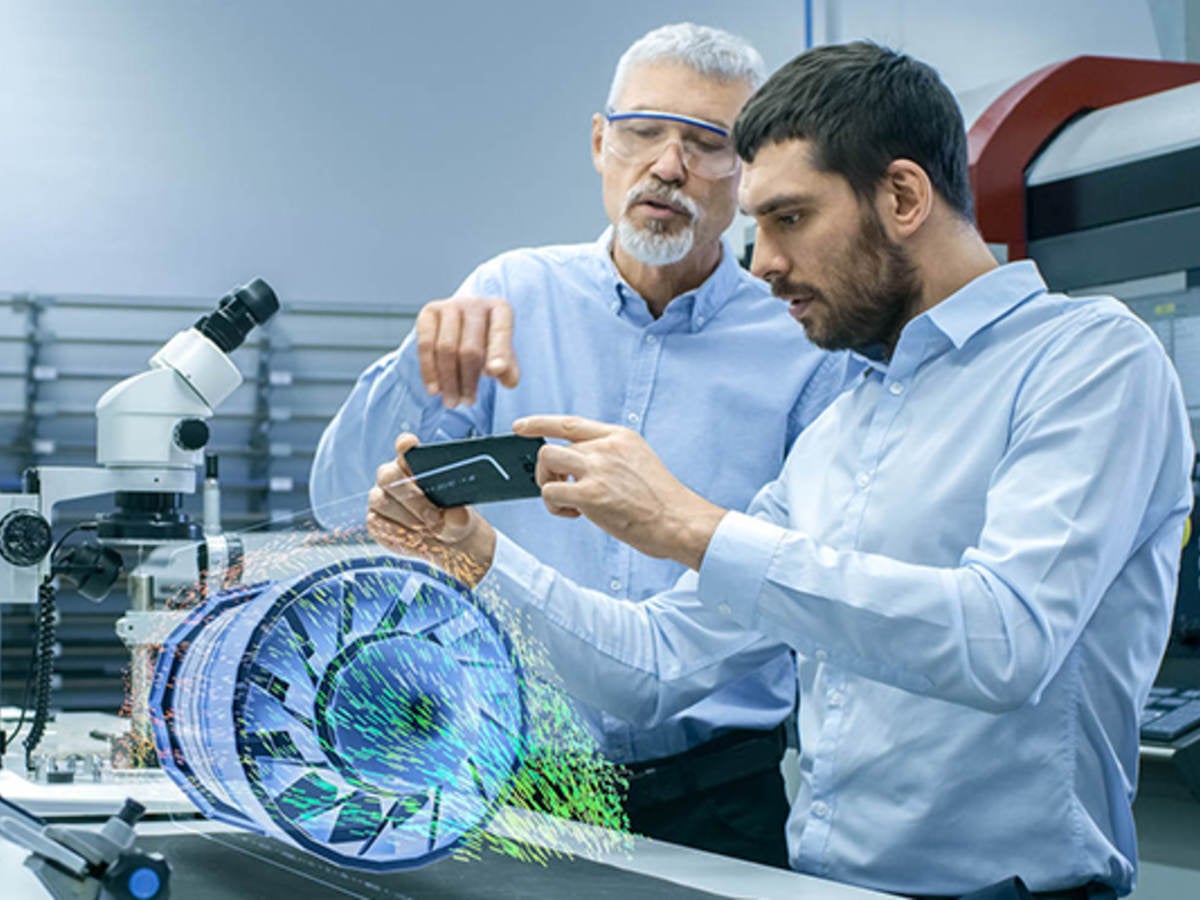 two male laboratory technicians observing a digital model