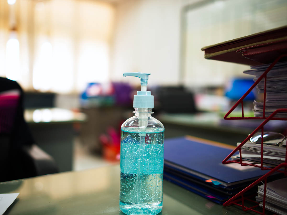 Bottle of hand sanitizing gel on an office desk