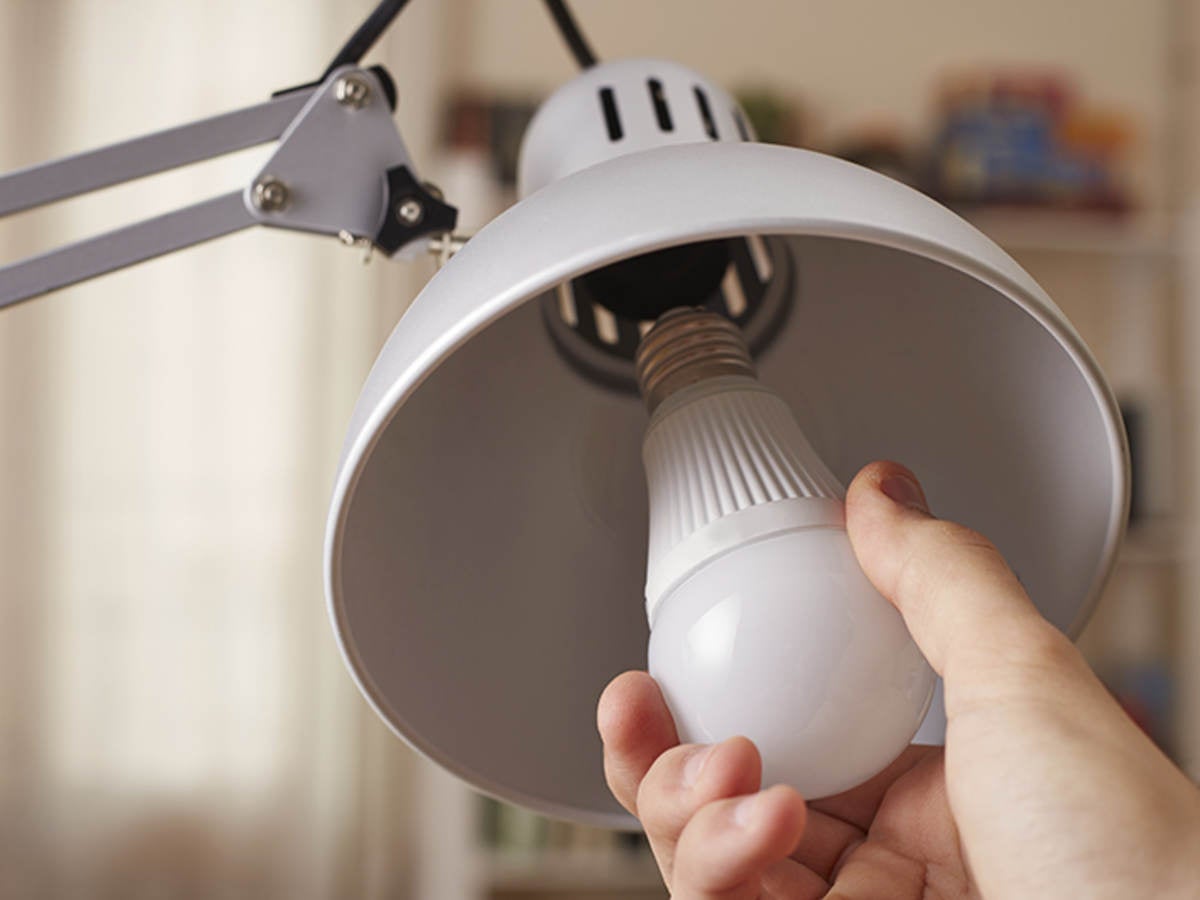 Person changing light bulb