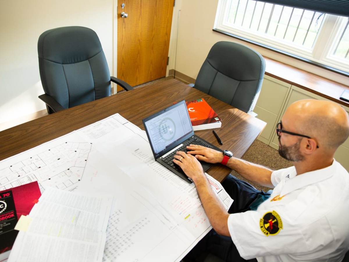 A code authority working at a laptop