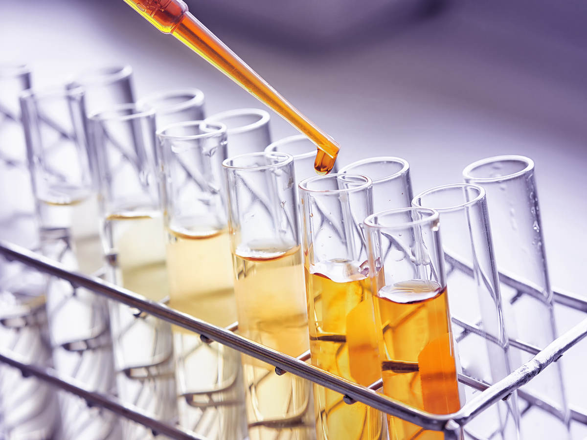 Test tubes and pipette containing an orange liquid