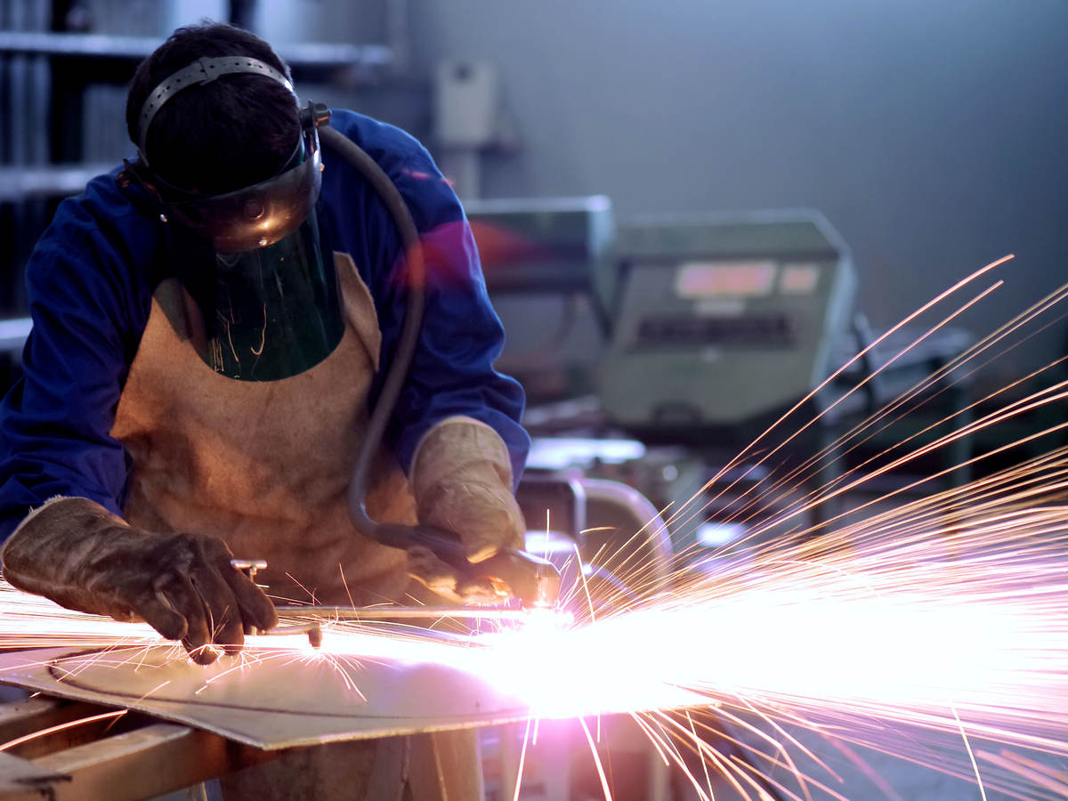 Welder cutting metal