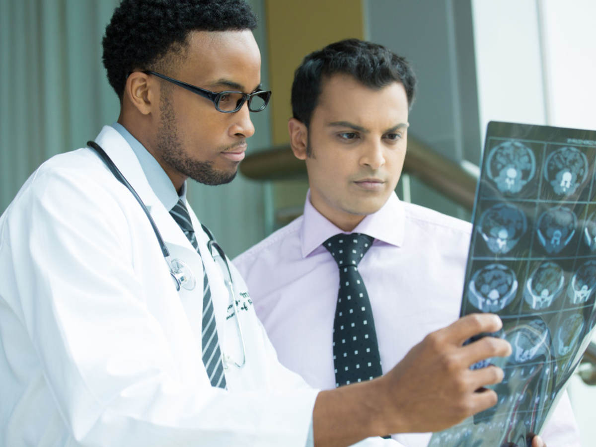 Two doctors examining a brain x-ray