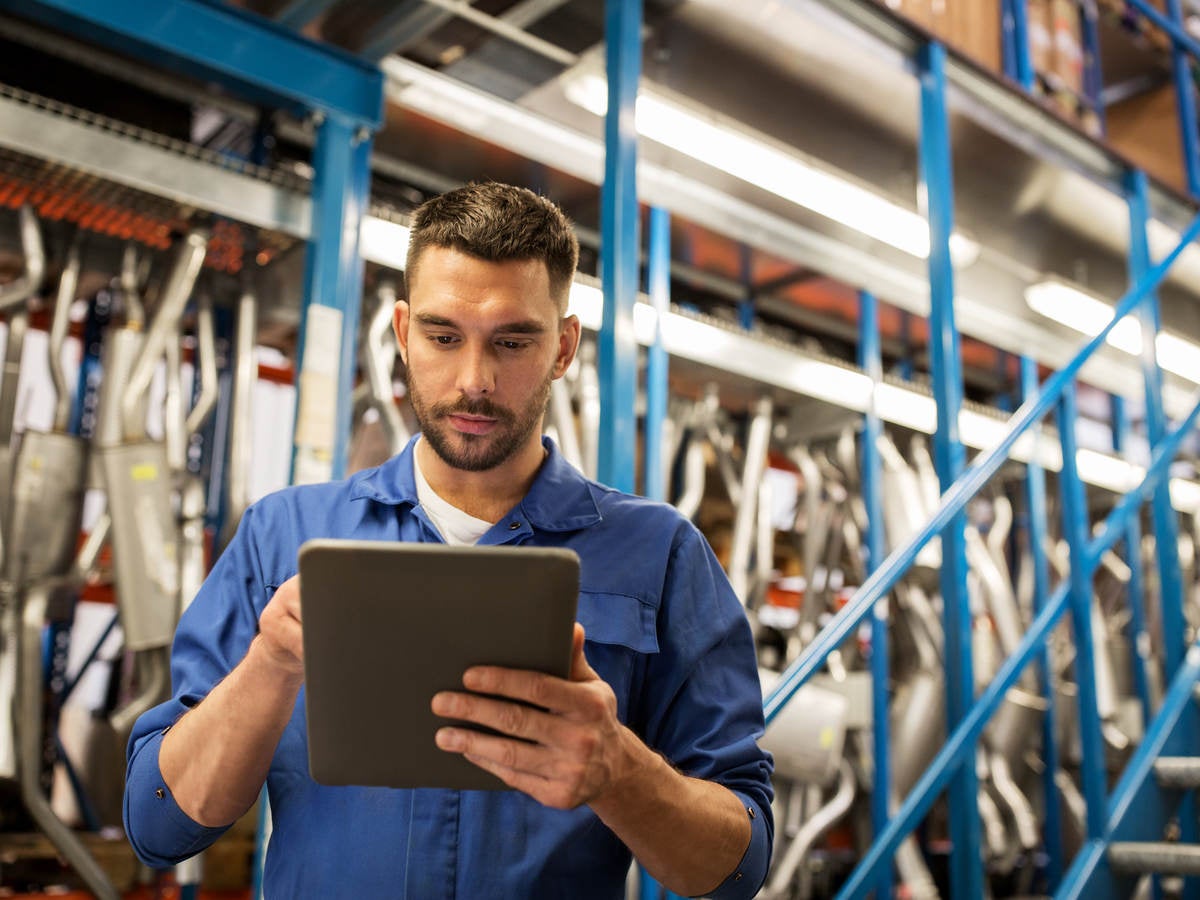 Worker in factory looking at a tablet