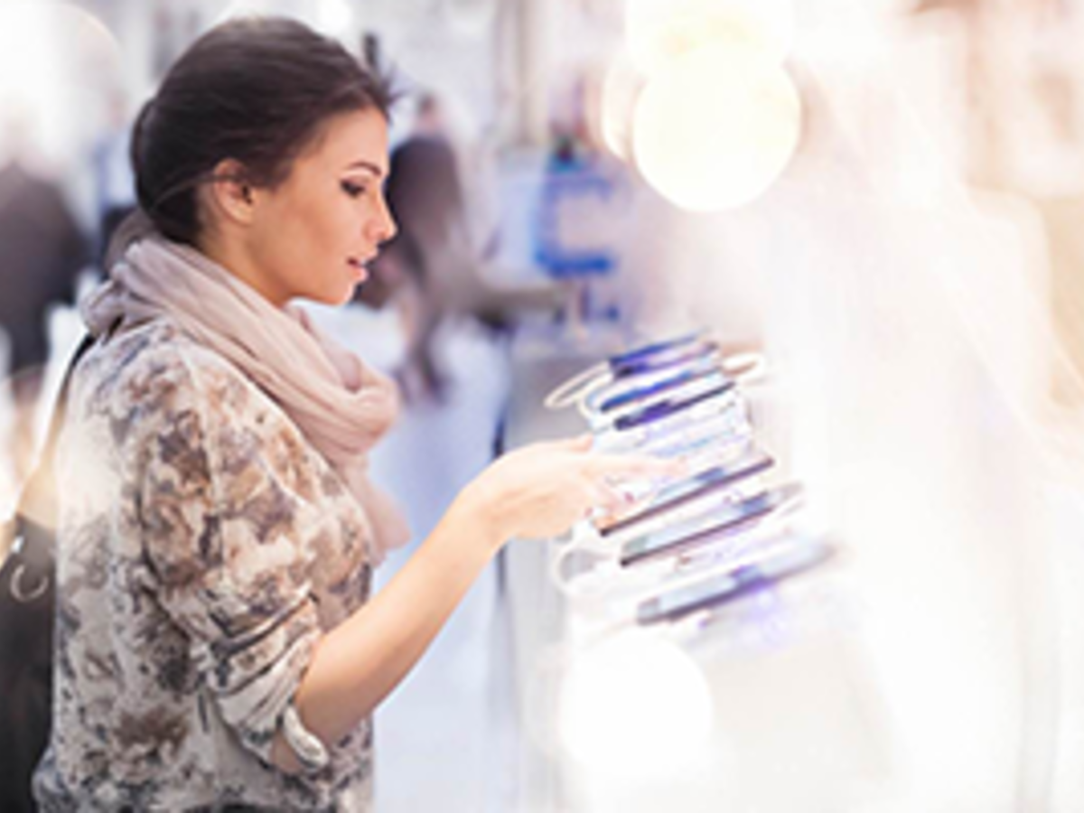 Lady viewing mobile phones in retail store
