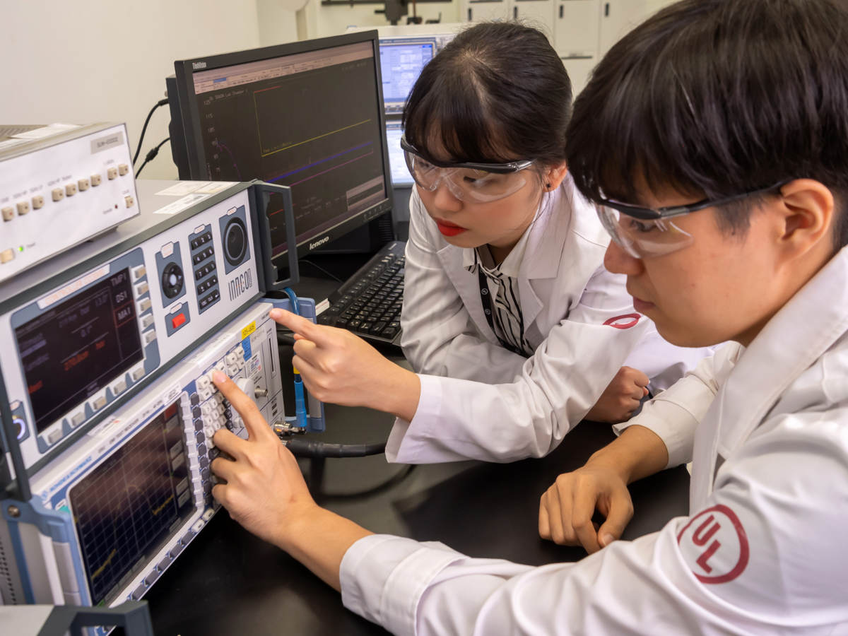 A male and female UL employee in Suwon Korea South Korea working with an EMC positioning system